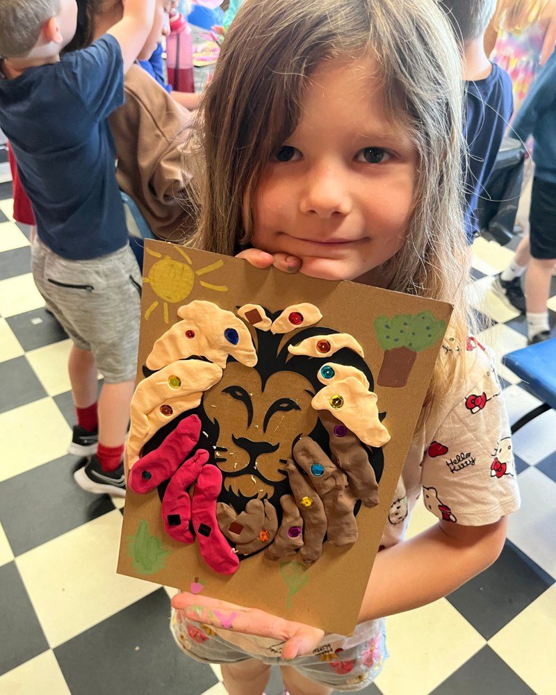 Maker with her clay lion